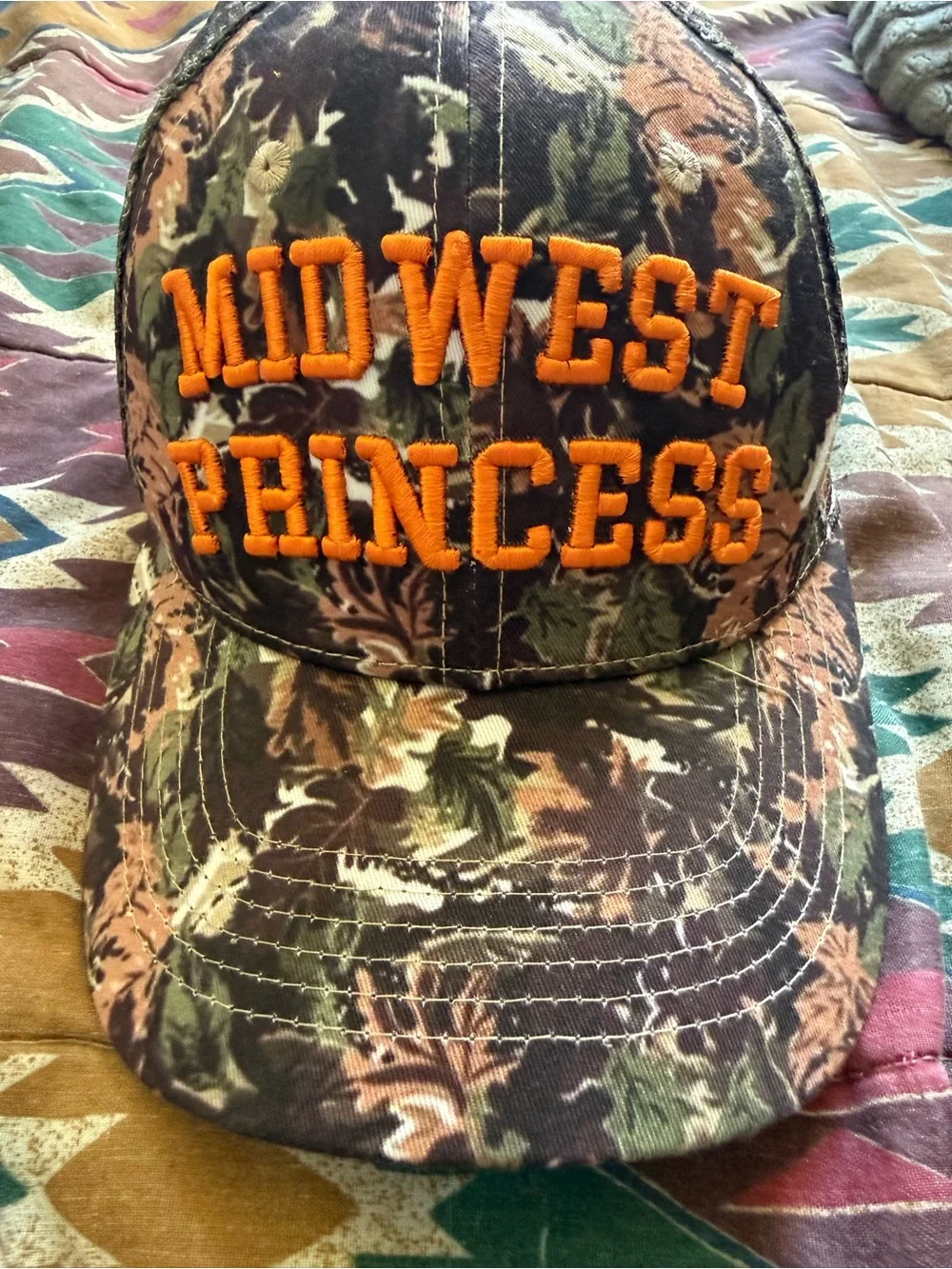 Camouflage 'Midwest Princess' Trucker Hat with Orange Embroidery Chappell Roan